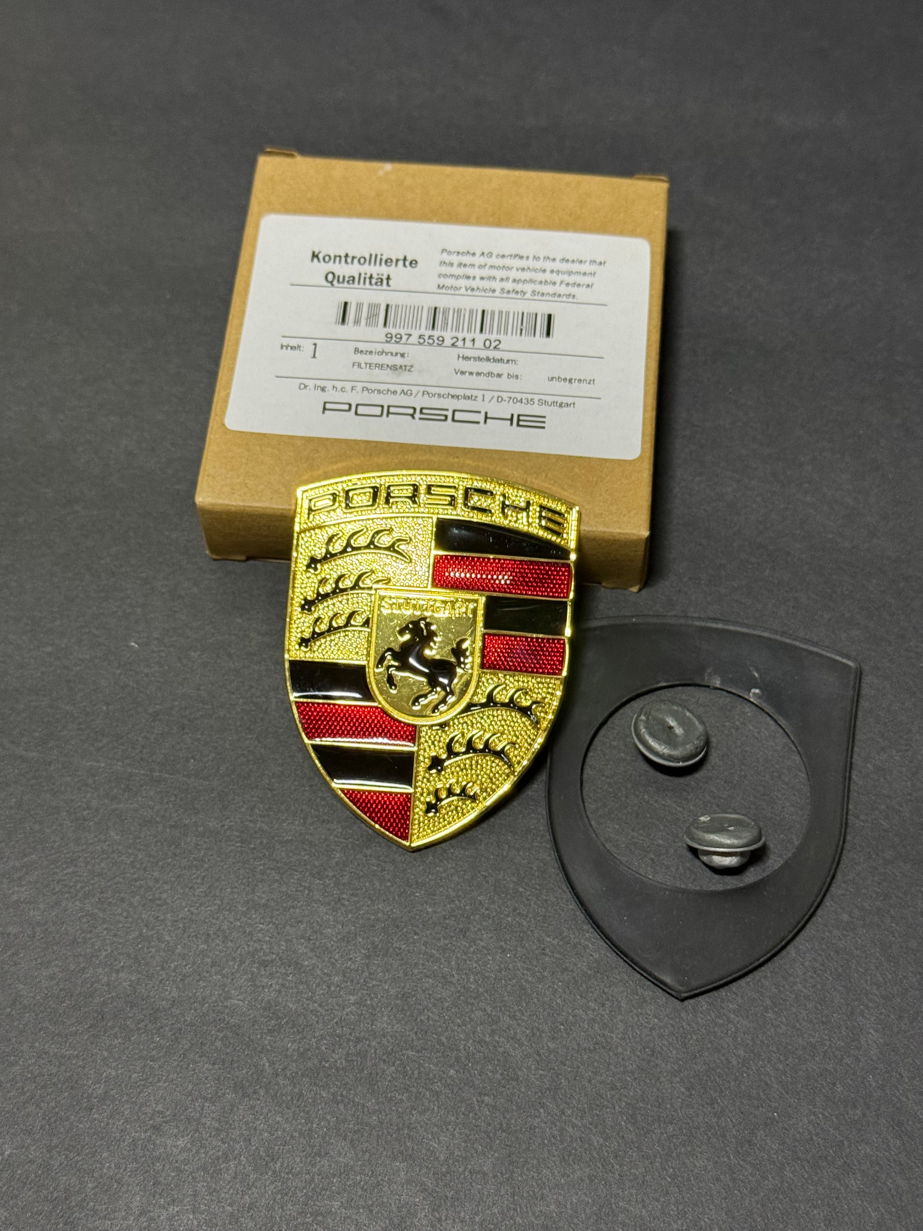 997 559 211 02 Porsche Hood Crest with Orange Bars and mounting hardware.